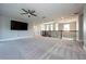 Bright loft space with ceiling fan, large television, and stairs with wrought iron railing at 108 Stanton Estates Cir, Winter Garden, FL 34787