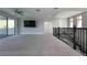 Bright loft space featuring a TV, ceiling fan, and stairs with wrought iron railing at 108 Stanton Estates Cir, Winter Garden, FL 34787