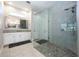 Modern main bathroom featuring a glass enclosed shower and vanity with double sinks at 108 Stanton Estates Cir, Winter Garden, FL 34787