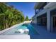 Backyard pool with in-pool seating and lush landscaping at 108 Stanton Estates Cir, Winter Garden, FL 34787