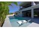 Inviting in-ground pool with in-water loungers and an covered outdoor space, perfect for relaxation and entertainment at 108 Stanton Estates Cir, Winter Garden, FL 34787