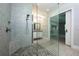 Modern bathroom featuring a glass enclosed shower with gray tile and a herringbone patterned floor at 108 Stanton Estates Cir, Winter Garden, FL 34787