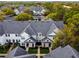 An aerial view shows the townhome's roof, landscaping, and neighborhood within a community at 130 Southern Pecan Cir # 205, Winter Garden, FL 34787