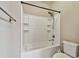 Bright bathroom featuring a bathtub with white tile surround, a shower head and built in shelving at 130 Southern Pecan Cir # 205, Winter Garden, FL 34787