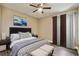 Comfortable bedroom with ceiling fan, modern decor and a decorative painting above the bed at 130 Southern Pecan Cir # 205, Winter Garden, FL 34787