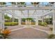Picturesque courtyard with a pergola, brick pavers, fountain, and lush tropical landscaping at 130 Southern Pecan Cir # 205, Winter Garden, FL 34787