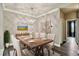 Elegant dining room featuring a dining table with seating for six, modern lighting, and artwork at 130 Southern Pecan Cir # 205, Winter Garden, FL 34787