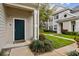 Exterior of home featuring a green door, lush landscaping and a walkway to the entrance at 130 Southern Pecan Cir # 205, Winter Garden, FL 34787