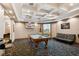 Bright game room with a coffered ceiling, pool table, sofa, and mounted television at 130 Southern Pecan Cir # 205, Winter Garden, FL 34787