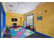 Vibrant playroom with colorful carpet, a TV, and various toys at 130 Southern Pecan Cir # 205, Winter Garden, FL 34787