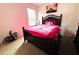 Bedroom with pink decor, a large wooden bed frame, and lots of natural light at 1823 Pristine Loop, Lakeland, FL 33811