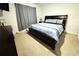 Bedroom with neutral carpet, a dark wood bed frame, and gray blackout curtains at 1823 Pristine Loop, Lakeland, FL 33811