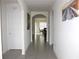 Bright hallway showcasing arched doorways and tile flooring, leading to other areas of the house at 1823 Pristine Loop, Lakeland, FL 33811