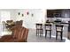 Open-concept kitchen and dining area featuring dark cabinetry, granite countertops, and seating at the kitchen island at 1823 Pristine Loop, Lakeland, FL 33811