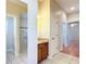 Bathroom vanity with wood cabinetry and granite counters with a walk-in shower at 2518 Foxbridge Ter, The Villages, FL 32162