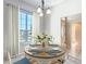 Bright dining room featuring a round table, white chairs, and a large window with natural light at 2518 Foxbridge Ter, The Villages, FL 32162