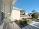 Exterior view with a table and chairs, showcasing the home's setting with landscaped surroundings at 2518 Foxbridge Ter, The Villages, FL 32162