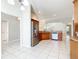 Kitchen featuring stainless refrigerator, light tile floors, and wood cabinets at 2518 Foxbridge Ter, The Villages, FL 32162