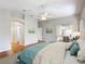 Well-lit main bedroom featuring a ceiling fan, with sliding door access to the patio at 2518 Foxbridge Ter, The Villages, FL 32162