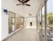 This sunroom has ceiling fans and sliding glass doors that let in natural light at 2518 Foxbridge Ter, The Villages, FL 32162