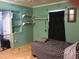 Bedroom featuring built-in shelves and a large window covered by a dark curtain at 894 Superior St, Deltona, FL 32725