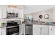 Modern kitchen with stainless steel appliances and a view into the cozy living area at 3193 Armstrong Ave, Clermont, FL 34714