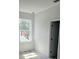 This bedroom has a window for natural light and a door that leads to another room or area of the home at 3611 Chelsea St, Orlando, FL 32803