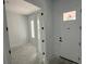 Bright entryway featuring white walls, a white front door with glass, and an open doorway at 3611 Chelsea St, Orlando, FL 32803