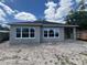 New construction exterior with two large windows and a dark roof against a cloudy sky at 3611 Chelsea St, Orlando, FL 32803