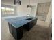 A large kitchen island featuring dark cabinetry, a sink, and a modern faucet at 3611 Chelsea St, Orlando, FL 32803
