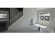 Bright living room with large windows, wooden stairs, and neutral color palette at 3611 Chelsea St, Orlando, FL 32803