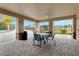 Poolside seating area with a table, chairs, and a view of the pool and playground at 2545 Penguin Blvd, Davenport, FL 33837