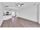 Bright living space with wood floors flowing into the open kitchen and a ceiling fan at 2674 Sw 165Th Street Rd, Ocala, FL 34473