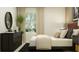 Bright bedroom featuring natural light, a black dresser, round mirror, and a decorative house plant at 2918 Pennachio Dr, Lake Wales, FL 33859