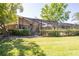 Spacious backyard featuring lush greenery, a screened-in lanai and a charming architectural home design at 105 Country Club Ln, Mulberry, FL 33860