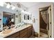 Well-lit bathroom with dual sinks, and a walk-in shower at 105 Country Club Ln, Mulberry, FL 33860