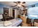Cozy bedroom featuring a plaid bedspread, ceiling fan, and a closet with bi-fold doors at 105 Country Club Ln, Mulberry, FL 33860