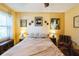 Bedroom featuring a ceiling fan, yellow walls, and artwork at 105 Country Club Ln, Mulberry, FL 33860