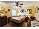 Bedroom featuring a ceiling fan, yellow walls, and artwork at 105 Country Club Ln, Mulberry, FL 33860
