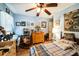 Sunlit bedroom with warm tile floors, ceiling fan, and inviting decor throughout the space at 105 Country Club Ln, Mulberry, FL 33860