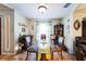 Bright dining room featuring a glass table, tile floors, and a decorative china cabinet at 105 Country Club Ln, Mulberry, FL 33860