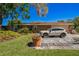 Well-maintained exterior of a home with lush lawn and a two-car garage at 105 Country Club Ln, Mulberry, FL 33860
