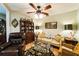 Comfortable living room featuring tile flooring, ceiling fan, and a cozy seating arrangement at 105 Country Club Ln, Mulberry, FL 33860