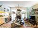 Inviting living room features a brick fireplace, vaulted ceilings, and seamless flow to the kitchen at 105 Country Club Ln, Mulberry, FL 33860