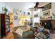 Cozy living room with fireplace, lots of decor and easy access to the kitchen at 105 Country Club Ln, Mulberry, FL 33860