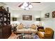 Traditional living room featuring tile floors, furniture, and ceiling fan at 105 Country Club Ln, Mulberry, FL 33860