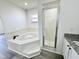 This bathroom features a soaking tub and a shower stall with glass doors at 1390 Patricia St, Kissimmee, FL 34744
