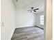 Bright, minimalist bedroom with a ceiling fan and wood-look flooring at 1390 Patricia St, Kissimmee, FL 34744