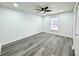 Bedroom with ceiling fan, vinyl floors, a window overlooking the pool and neutral walls at 1390 Patricia St, Kissimmee, FL 34744