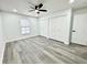 Comfortable bedroom featuring luxury vinyl floors and a window overlooking the pool at 1390 Patricia St, Kissimmee, FL 34744